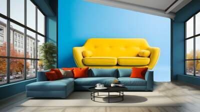 Yellow sofa, isolated on blue background Wall mural