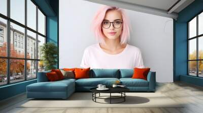 Young beautiful pink hair woman model in white t-shirt posing on light background Wall mural