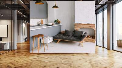 Interior of the modern loft kitchen-studio in the apartment. Room, furniture, sofa near wooden fireplace Wall mural