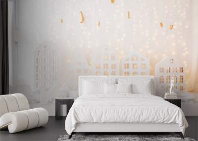 New Year and Christmas background wooden toy houses ,snowflakes ,paper trees on the white background Wall mural