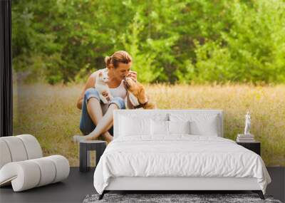 Animal lover sitting outside with her pets Wall mural