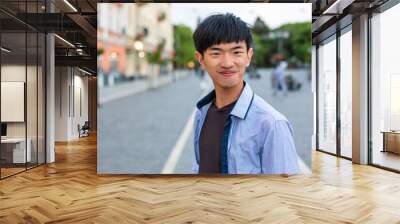 Attractive young student on old european city background Wall mural