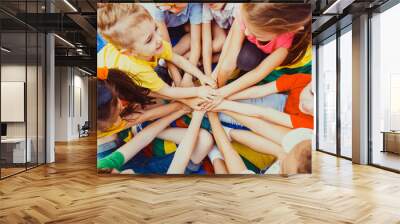 Group of children putting their hands together Wall mural