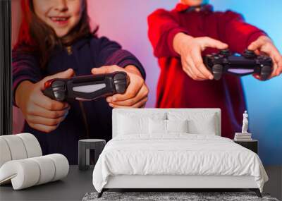 Happy friends holding joysticks and start virtual game Wall mural