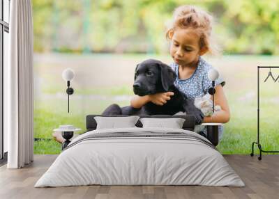 Little girl taking care of her dog and cat Wall mural