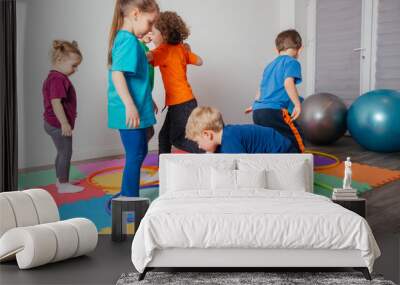 Sport activities with hula hoops at kindergarten Wall mural