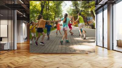 The happy children are having fun in the park Wall mural