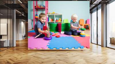 the little kids learning different skills in the kindergarten Wall mural