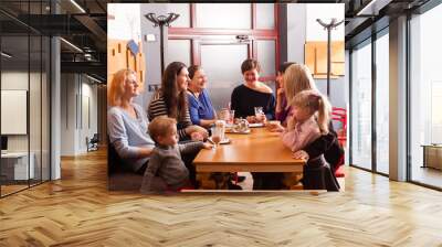 Women and children having a drink Wall mural