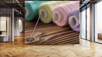 sewing needle on a wooden background in thread Wall mural