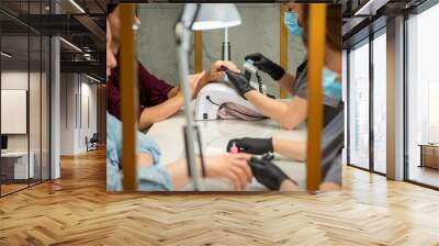 Two women getting a manicure treatment in beauty salon Wall mural