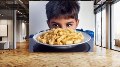 a plate of pasta and a child behind it Wall mural