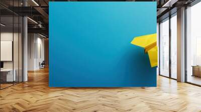 Yellow paper plane business strategy on blue background Wall mural