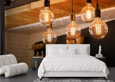 Decorative antique LED tungsten light bulbs hanging on ceiling. Wall mural