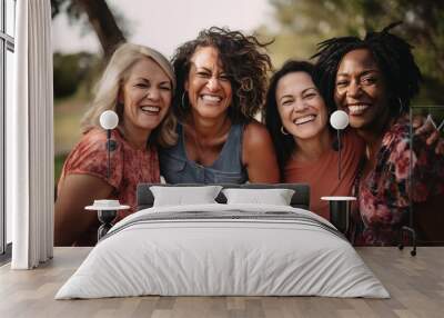 portrait of four women middle age in a close, affectionate embrace, exuding a sense of unity and gen Wall mural