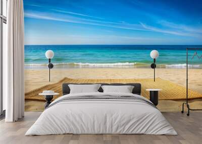 Straw mat lying on a sandy beach with clear blue sea in the background, straw mat, beach, sand, ocean, summer Wall mural