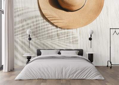  Straw hat and palm leaf shadow on beige linen cloth material background Wall mural