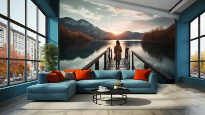  a person standing on a dock looking at the water and mountains in the distance with a sunset in the background and a person standing on the end of the dock.  generative ai Wall mural