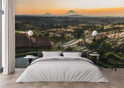 Famous Bali landmark Jatiluwih rice terraces. Beautiful sunrise view of green hills and mount Agung on horizon. Wanderlust concept and nature background. Wall mural