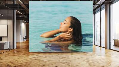 Portrait of young woman enjoying and relaxing in clean transparent ocean water. Leisure, carefree and vacation concept. Wanderlust travel in Asia. Wall mural