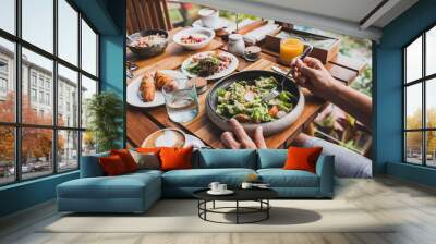 View from above on table with fresh breakfast. Man hands holding fork and knife Wall mural