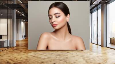 Beautiful Young Woman with clean fresh skin look away. Girl beauty face care. Facial treatment. Cosmetology, beauty and spa Wall mural