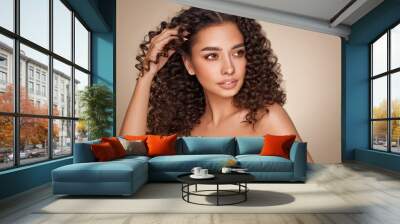 Fashion studio portrait of beautiful smiling woman with afro curls hairstyle. Fashion and beauty Wall mural