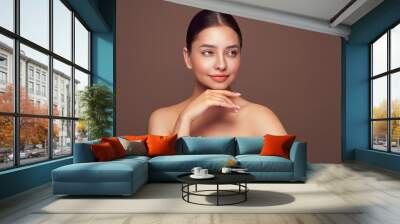 Portrait beautiful young woman with clean fresh skin. Model with healthy skin looks at an empty space, close up portrait. Cosmetology, beauty and spa Wall mural