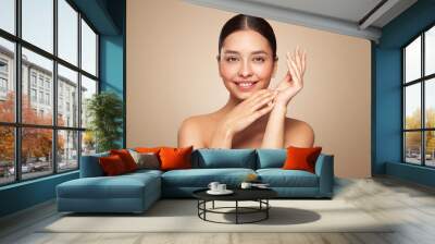 Portrait beautiful young woman with clean fresh skin. Model with healthy skin looks at an empty space, close up portrait. Cosmetology, beauty and spa Wall mural