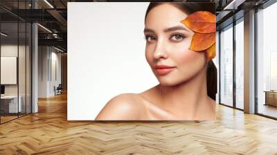 Portrait of beautiful young woman with autumn leafs. Healthy clean fresh skin natural make up beauty eyes and red nails Wall mural