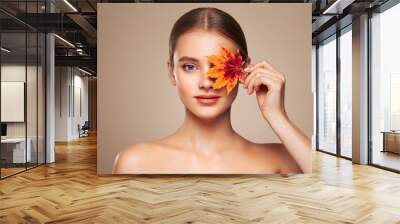 Portrait of beautiful young woman with autumn leafs. Healthy clean fresh skin natural make up beauty eyes Wall mural