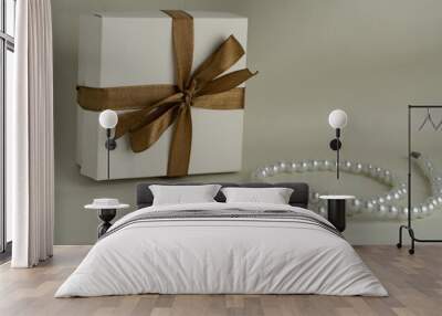 gift box with ribbon and pearl necklace on textured leather Wall mural