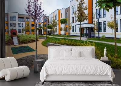 Green recreation area in the courtyard of a multi-storey building Wall mural