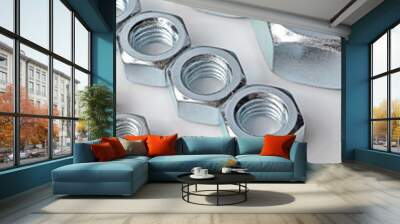 New, chrome new nuts of different sizes on a white background. Wall mural