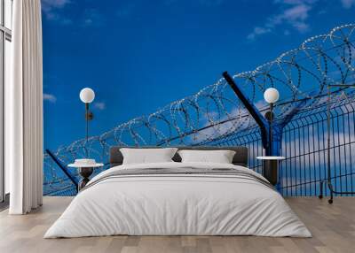 barbed wire fence against the blue sky Wall mural