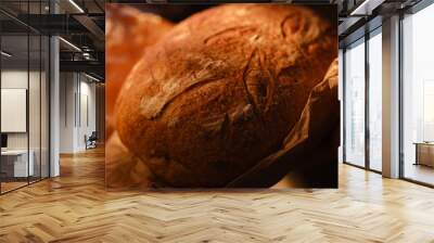 Assortment of baked bread on wooden table background. Bread background, top view of white, black and rye loaves. Healthy food.  Wall mural