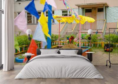 sandbox with wind toys in the sand on playground Wall mural