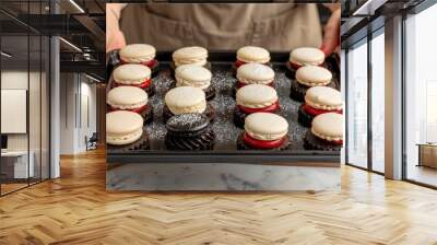 Talented baker arranging colorful macarons and petit fours for an elegant dessert display Wall mural