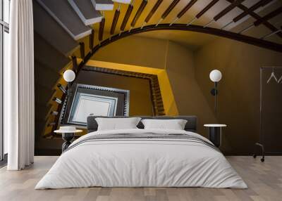 Upside view of a spiral staircase Wall mural