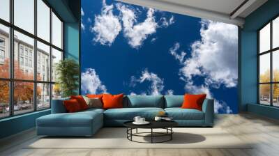 white clouds against blue sky in sunny weather Wall mural