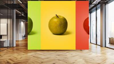 Set of wet green, yellow and red apples on the same color background like apple. Wall mural