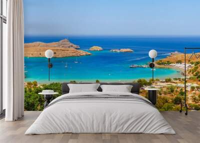 Sea skyview landscape photo Lindos bay and castle on Rhodes island, Dodecanese, Greece. Panorama with ancient castle and clear blue water. Famous tourist destination in South Europe Wall mural