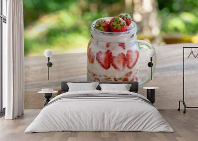 Almond milk chia pudding with fresh red strawberries, goji berries and oat flakes in a glass jar mug. Vegan raw breakfast. Chia seeds and fresh cut fruits and berries dessert Wall mural