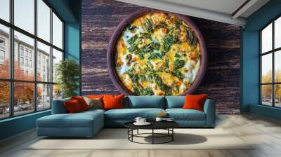 Ceramic bowl with vegetable frittata, simple vegetarian food. Frittata with egg, pepper, onion, cheese and green wild garlic leaves on table Wall mural