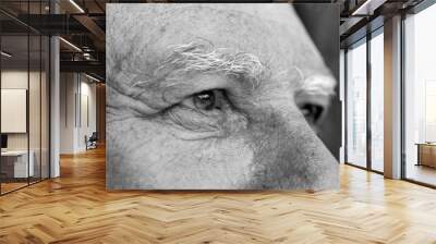 Closeup eye of caucasian old man. Portrait of old man outdoors. Caucasian male face background, close up eyes, macro, black and white Wall mural