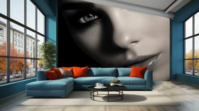 A black and white image of a model's face with a dramatic winged eyeliner and long lashes Wall mural