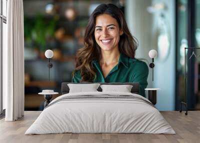 attractive business woman smiling with arms crossed in office Wall mural