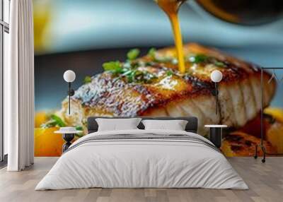 Chef pouring sauce over grilled salmon with seasonal fruits on a plate in a fine dining setting Wall mural