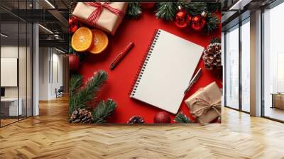 Christmas decorations featuring gifts, oranges, and a blank notebook on a festive table Wall mural