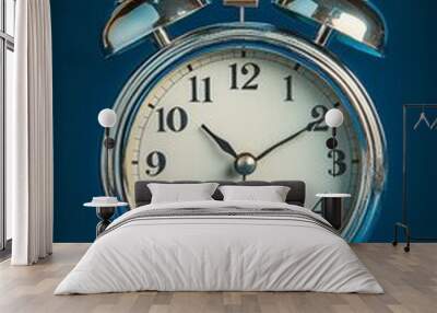 Classic silver alarm clock showing 6:00 against a dark blue background in a vintage style Wall mural